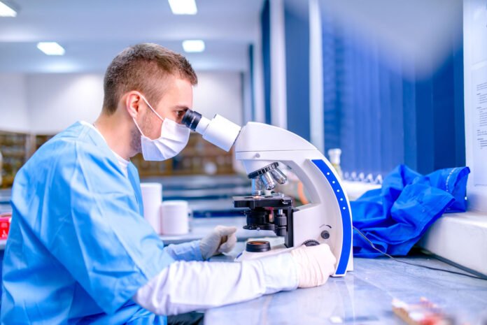 Scientist working in chemistry laboratory, examining samples at